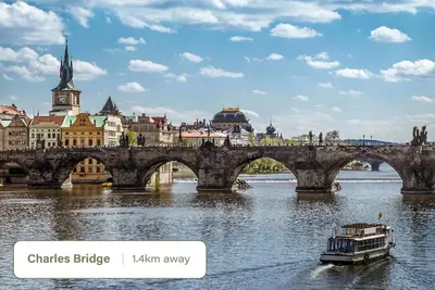 a bridge over a river with a boat at HOMELY I Central 44m2 APT I ELEVATOR I Self Check-In in Prague