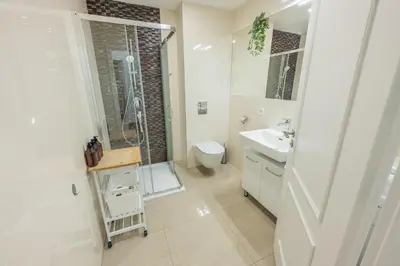 a bathroom with a toilet and a shower and a sink at HOMELY I Central 44m2 APT I ELEVATOR I Self Check-In in Prague