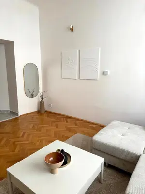 a living room with a white couch and a table at City center apartment in Prague