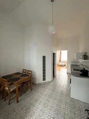 a kitchen and dining room with a table and chairs at City center apartment in Prague