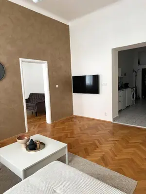a living room with a white couch and a table at City center apartment in Prague