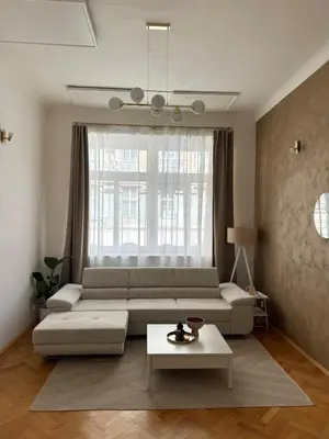 a living room with a couch and a table at City center apartment in Prague