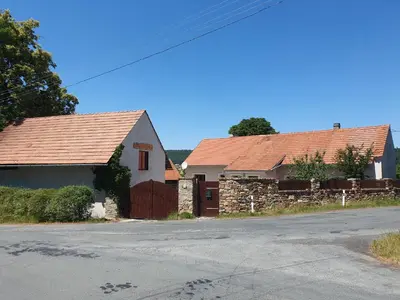 two houses with red roofs on the side of a street at Statek U Šimla in Lážovice