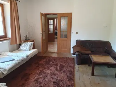 a living room with a couch and a table at Statek U Šimla in Lážovice