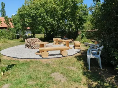 a picnic table and chairs in a yard at Statek U Šimla in Lážovice