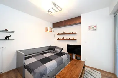 a bedroom with a bed and a table at New Apartment in Heart of Prague in Prague