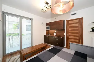 a bedroom with a bed and a sink and a mirror at New Apartment in Heart of Prague in Prague
