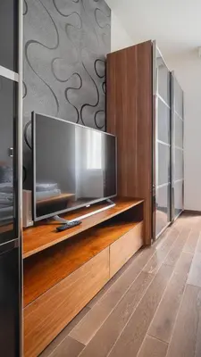 a large flat screen tv on a wooden entertainment center at Botanical Escape Apartment in Prague