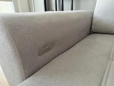 a white couch with a remote control on it at City view Apartment Lenka in Prague