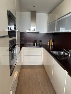 a kitchen with white cabinets and a sink at City view Apartment Lenka in Prague