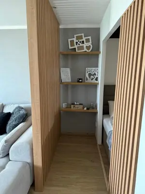 a living room with a couch and shelves at City view Apartment Lenka in Prague