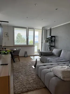 a living room with a couch and a table at City view Apartment Lenka in Prague