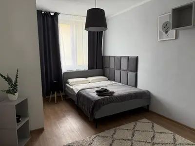 a bedroom with a bed with a black headboard at City view Apartment Lenka in Prague