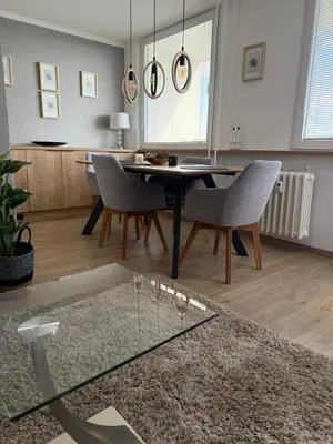 a living room with a dining room table and chairs at City view Apartment Lenka in Prague