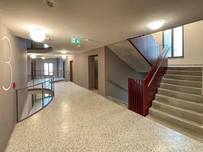 a hallway with a staircase in a building at New Apartment, close Prague center, Free Parking in Prague