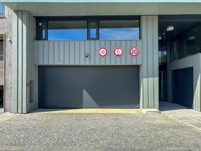 a garage door with two no parking signs on it at New Apartment, close Prague center, Free Parking in Prague