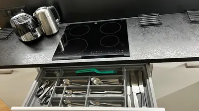 a drawer in a kitchen with utensils at New Apartment, close Prague center, Free Parking in Prague