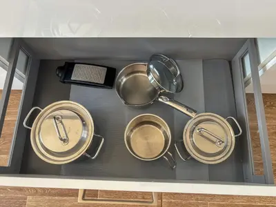 a group of pots and pans in a drawer at New Apartment, close Prague center, Free Parking in Prague