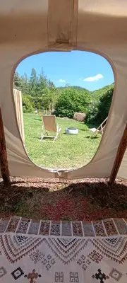 a view of a tent with a chair in a field at Tee-pee u Honzíka in Zbečno
