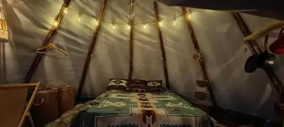 a bedroom with a bed in a tent at Tee-pee u Honzíka in Zbečno
