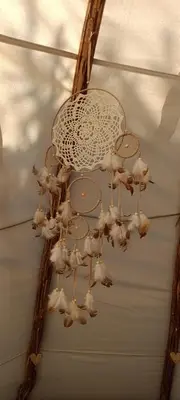 a chandelier with chickens hanging from the ceiling at Tee-pee u Honzíka in Zbečno