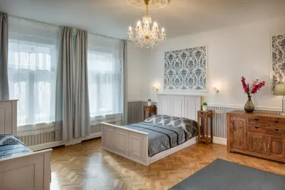 a bedroom with a bed and a chandelier at Veleslavinova - Old Town Apartment in Prague