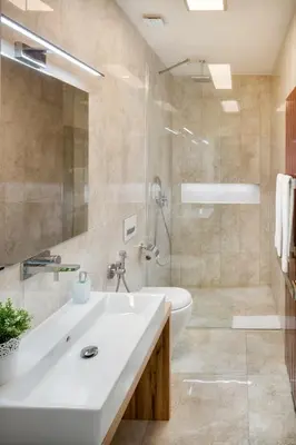a bathroom with a white sink and a shower at Veleslavinova - Old Town Apartment in Prague