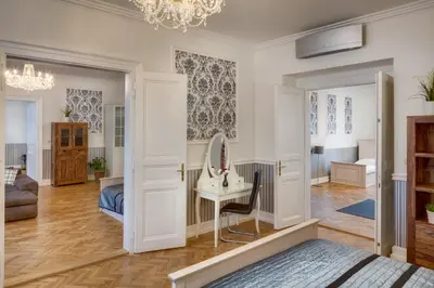 a bedroom with a bed and a dressing table and a mirror at Veleslavinova - Old Town Apartment in Prague