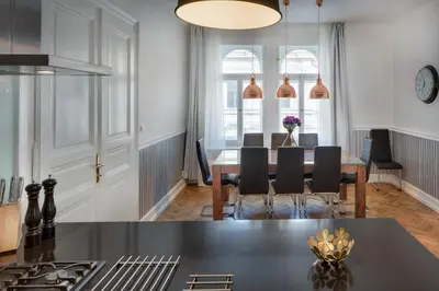 a kitchen and dining room with a table and chairs at Veleslavinova - Old Town Apartment in Prague