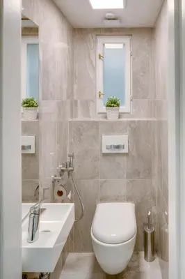 a bathroom with a white toilet and a sink at Veleslavinova - Old Town Apartment in Prague