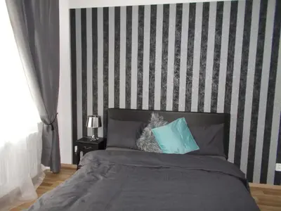 a bed with two blue pillows on top of it at Top Wenceslas Square Apartment in Prague