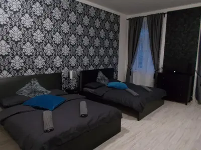 a bedroom with two beds and a wall at Top Wenceslas Square Apartment in Prague