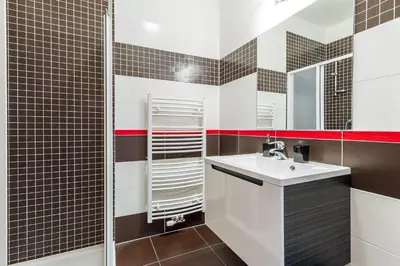 a bathroom with a sink and a mirror at Top Wenceslas Square Apartment in Prague