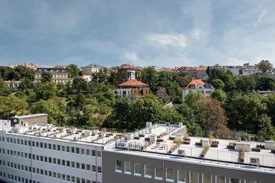 a view of a building with trees and buildings at Vila Grebovka in Prague