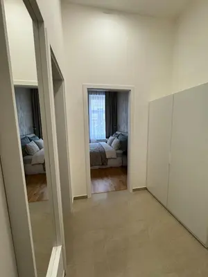 an empty room with a bed and a mirror at Apartment with free garage parking in Prague