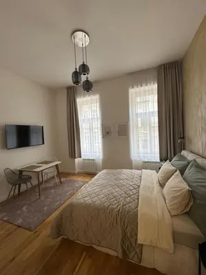 a bedroom with a bed and a table in it at Apartment with free garage parking in Prague