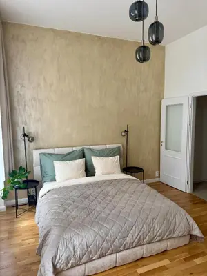 a bedroom with a large bed and a wall at Apartment with free garage parking in Prague