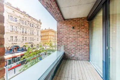 a balcony of a building with a view of a street at Rentero Spacious Smíchov 2 Bedroom Apartment with Excellent Tram Connection in Prague