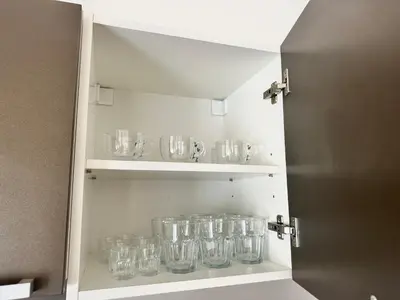 a cupboard full of empty glasses sitting on a shelf at 2BR Gateway on the Rybna in Prague