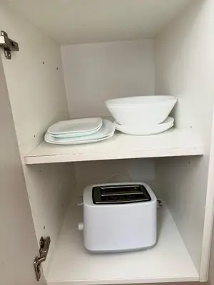 a kitchen with a toaster and plates on a shelf at 2BR Gateway on the Rybna in Prague