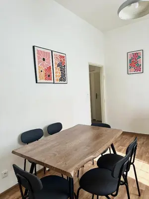 a room with a wooden table and chairs at 2BR Gateway on the Rybna in Prague