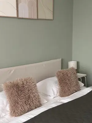 a bed with two faux fur pillows on it at 2BR Gateway on the Rybna in Prague
