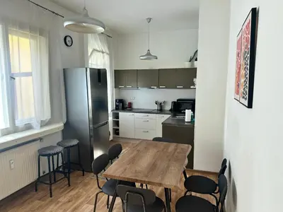 a kitchen with a table and chairs and a refrigerator at 2BR Gateway on the Rybna in Prague