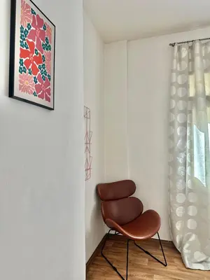 a brown chair in a room with a window at 2BR Gateway on the Rybna in Prague