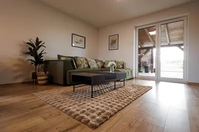 a living room with a couch and a coffee table at Pool Villa Mukařov in Srbín