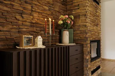 a dresser with candles and flowers in a room at Pool Villa Mukařov in Srbín