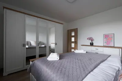 a bedroom with a bed with two towels on it at Pool Villa Mukařov in Srbín
