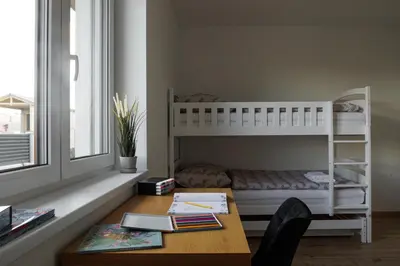 a room with a bunk bed and a desk with a desk at Pool Villa Mukařov in Srbín