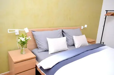 a bedroom with a bed with blue sheets and pillows at Central one bedroom apartment in Prague