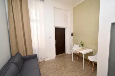 a living room with a couch and a table at Central one bedroom apartment in Prague